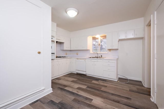 kitchen featuring white cabinets, white appliances, sink, and dark wood-type flooring