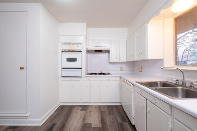 kitchen with sink, white cabinets, dark wood-type flooring, and white appliances