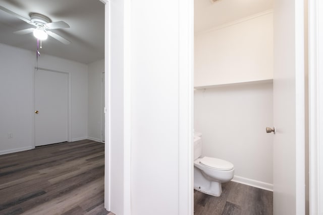 bathroom with hardwood / wood-style flooring, toilet, and ceiling fan