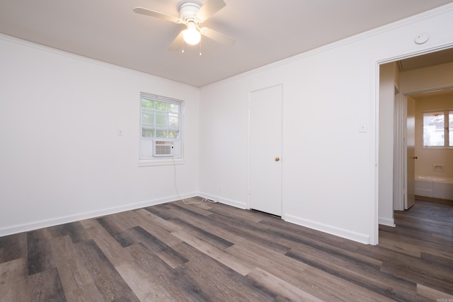 spare room featuring ceiling fan, crown molding, cooling unit, and dark wood-type flooring