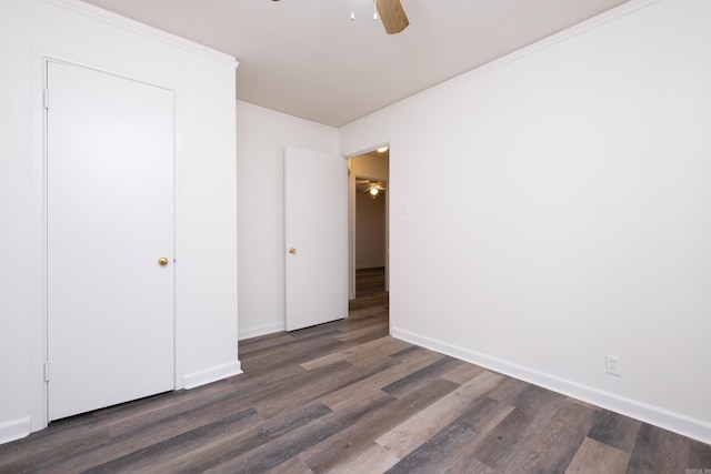 unfurnished bedroom featuring ceiling fan, dark hardwood / wood-style floors, and ornamental molding