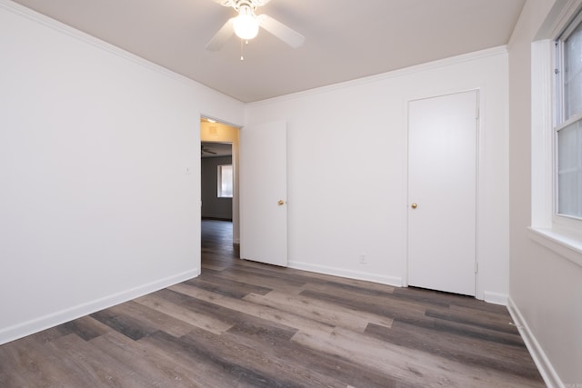 spare room featuring dark hardwood / wood-style floors, ceiling fan, and ornamental molding