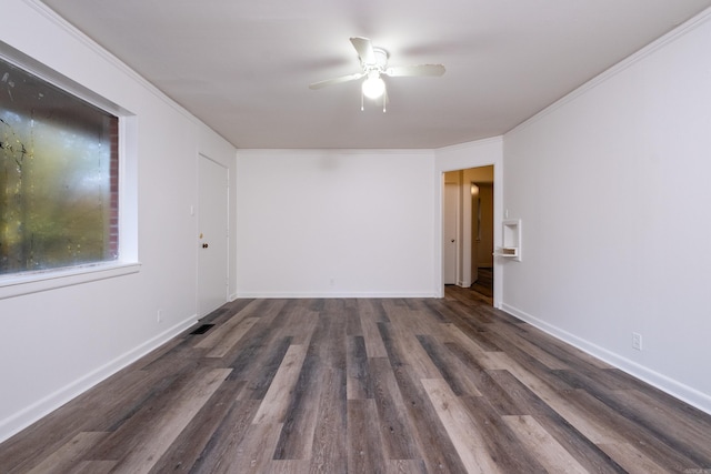 spare room featuring dark hardwood / wood-style floors, ceiling fan, and crown molding