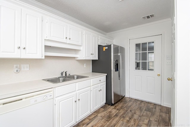 kitchen with white dishwasher, white cabinetry, and sink