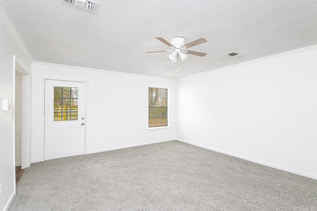 carpeted empty room featuring a textured ceiling, ceiling fan, and ornamental molding