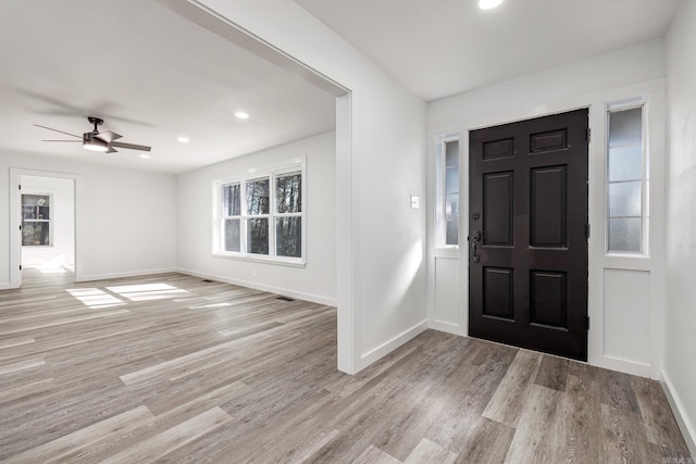 foyer featuring ceiling fan, light hardwood / wood-style floors, and a wealth of natural light