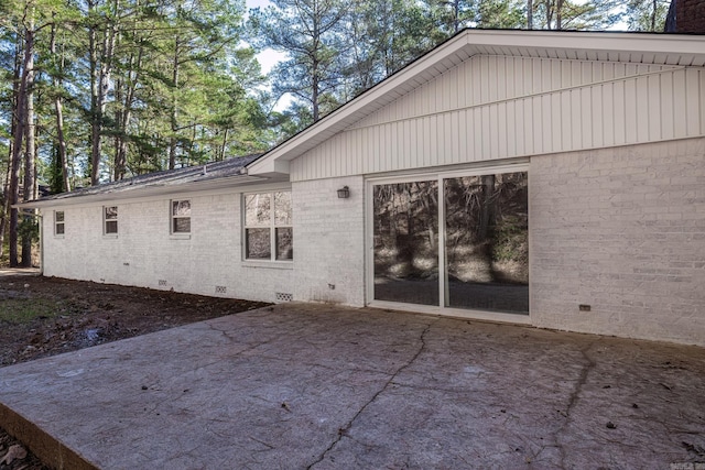 view of side of property with a patio area