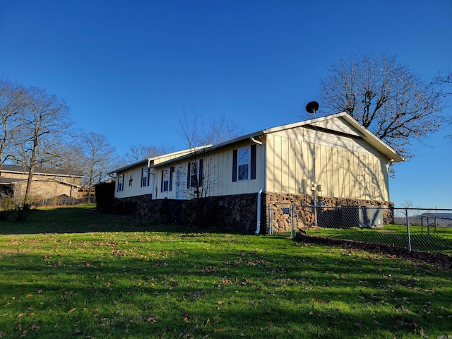 view of side of home featuring a yard