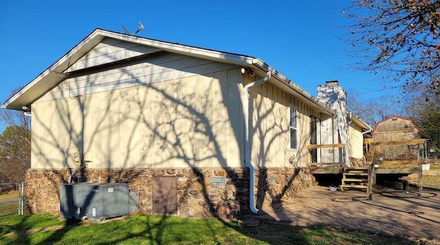 view of side of home with a deck