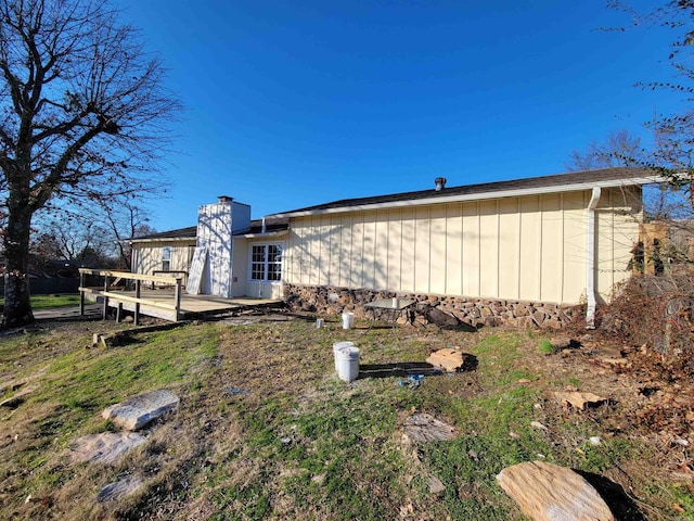 view of side of home with a wooden deck