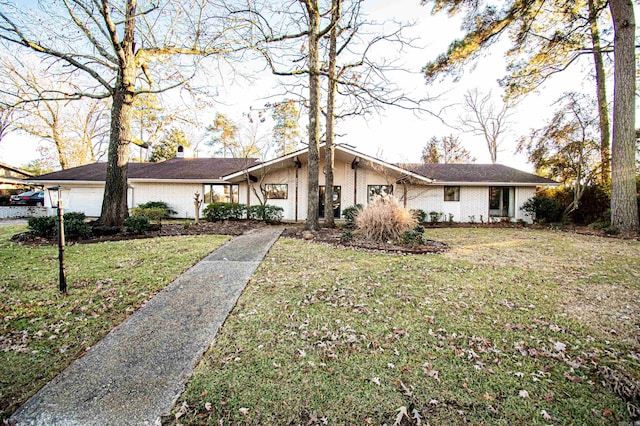 single story home with a garage and a front lawn