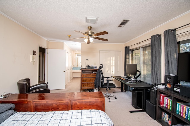 carpeted bedroom featuring ceiling fan, crown molding, and a textured ceiling