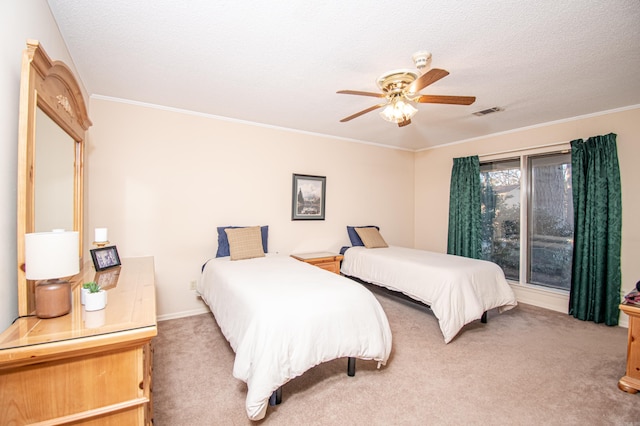 carpeted bedroom featuring a textured ceiling, ceiling fan, and crown molding