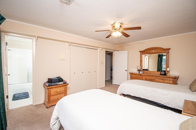 bedroom featuring ceiling fan, light colored carpet, ensuite bathroom, and crown molding