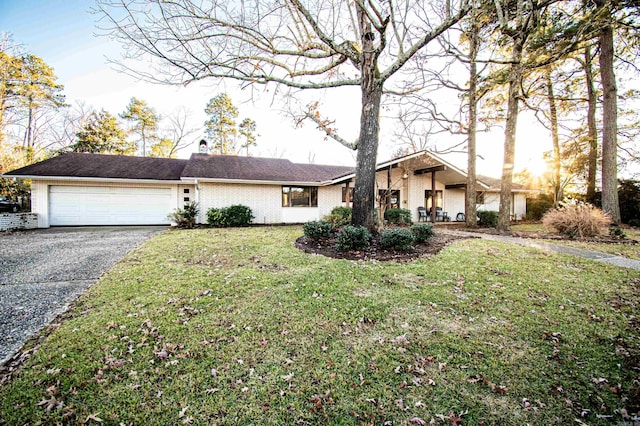 single story home with a front lawn and a garage