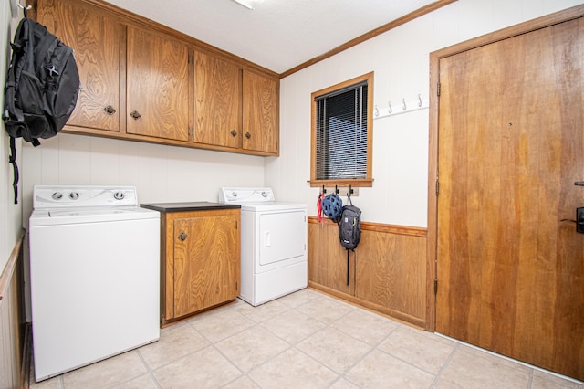 laundry area featuring cabinets, wooden walls, and ornamental molding