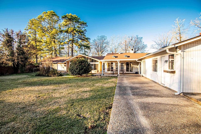 ranch-style home with covered porch and a front lawn