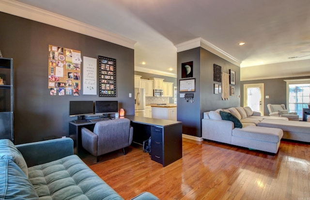 living room with hardwood / wood-style floors and crown molding