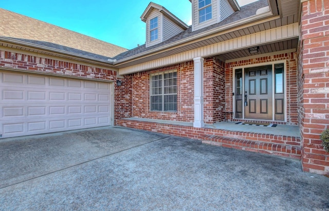 doorway to property featuring covered porch and a garage