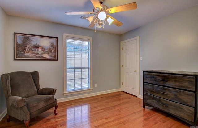 sitting room featuring light wood-type flooring and ceiling fan