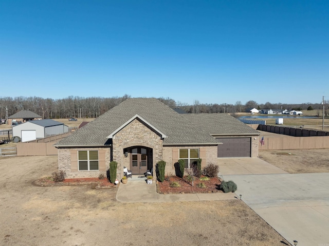 view of front of property with a garage and french doors