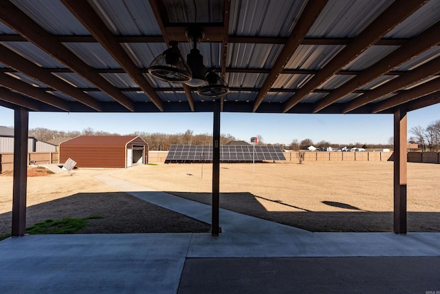 view of patio featuring a storage unit