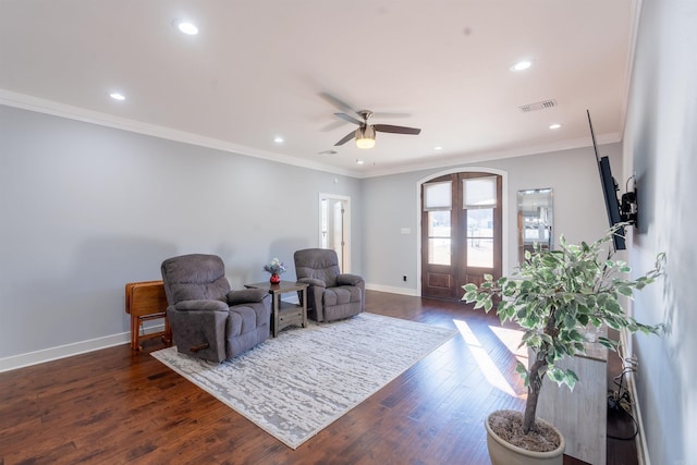 sitting room with dark hardwood / wood-style floors, ceiling fan, crown molding, and french doors