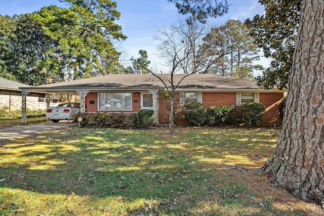 ranch-style house featuring a carport and a front lawn