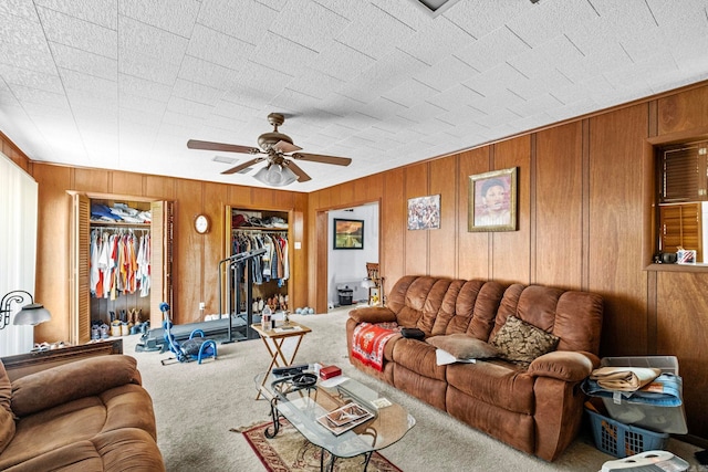 carpeted living room with ceiling fan