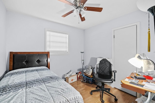 bedroom with ceiling fan and hardwood / wood-style flooring