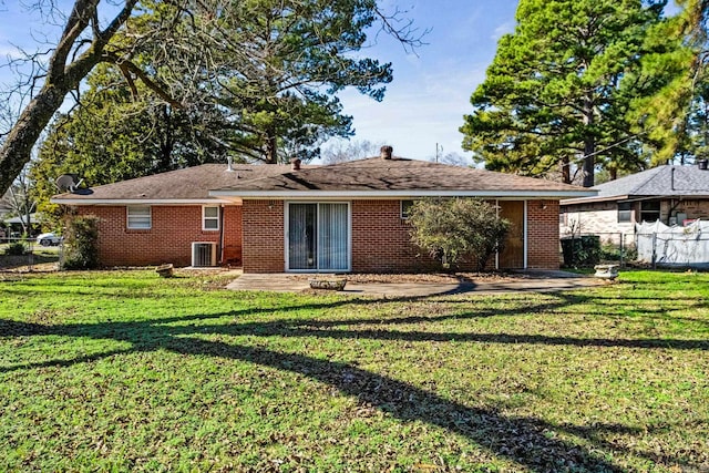 rear view of house featuring a yard, central AC, and a patio area