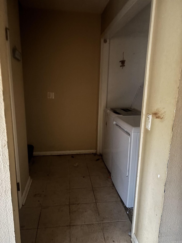 clothes washing area with independent washer and dryer and light tile patterned floors