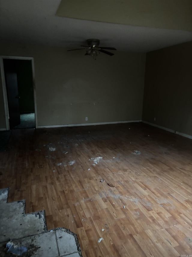 empty room with hardwood / wood-style flooring and ceiling fan