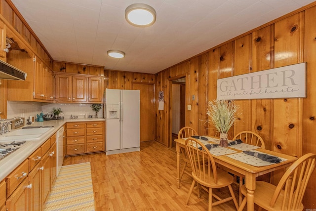 kitchen with sink, light hardwood / wood-style floors, and white appliances