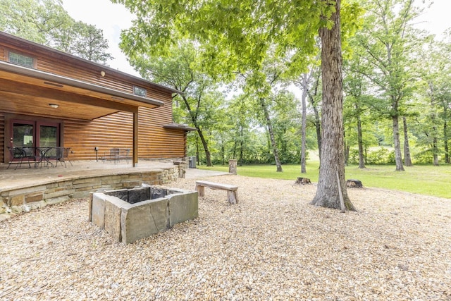 view of yard featuring french doors, a patio, and a fire pit