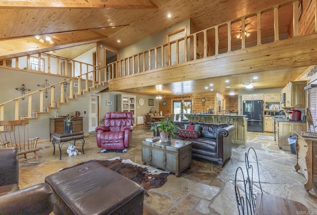 living room with a high ceiling, ceiling fan, and wooden ceiling