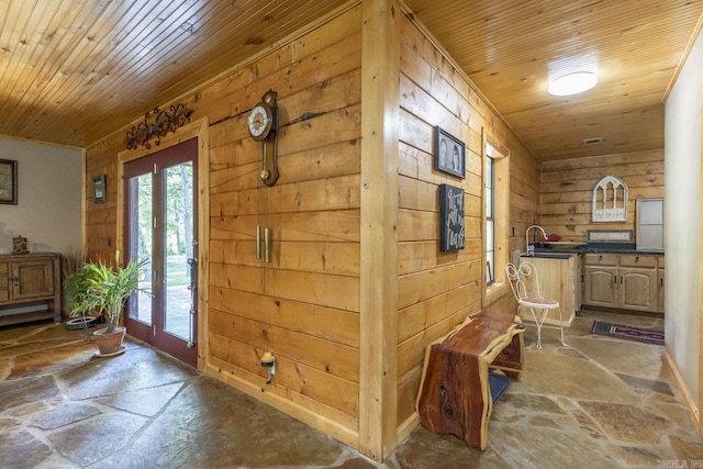 interior space featuring wooden walls, french doors, and wooden ceiling