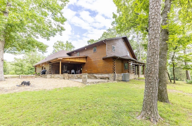 back of property featuring a lawn and central AC unit