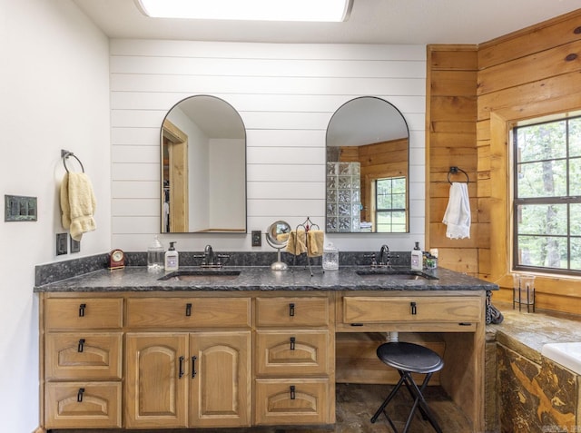 bathroom with wood walls and vanity