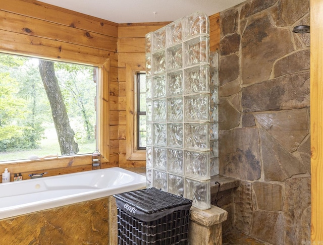 bathroom featuring plus walk in shower and a wealth of natural light