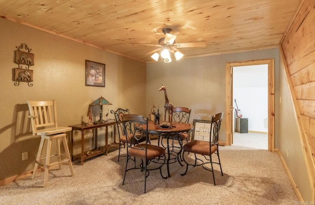 dining area featuring light carpet, ceiling fan, crown molding, and wood ceiling