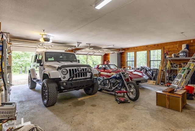 garage featuring wooden walls and a garage door opener