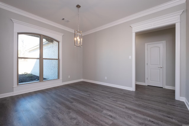 empty room with a chandelier, dark hardwood / wood-style floors, and crown molding