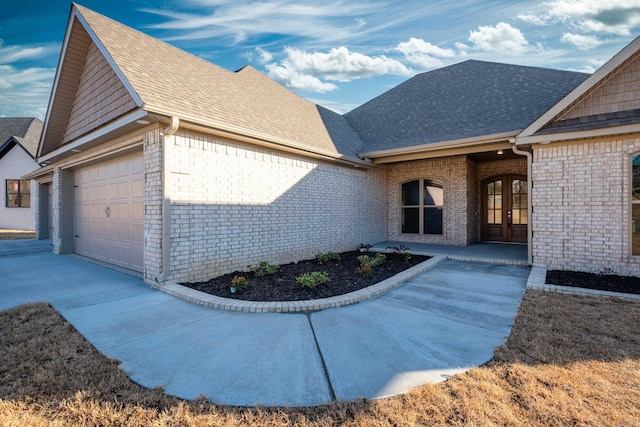 exterior space with a garage and french doors