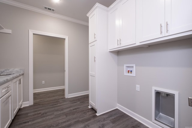 clothes washing area featuring washer hookup, dark hardwood / wood-style floors, cabinets, and crown molding