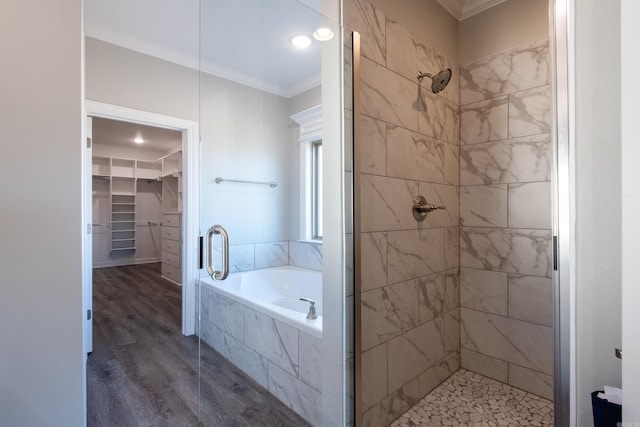 bathroom with shower with separate bathtub, ornamental molding, and wood-type flooring