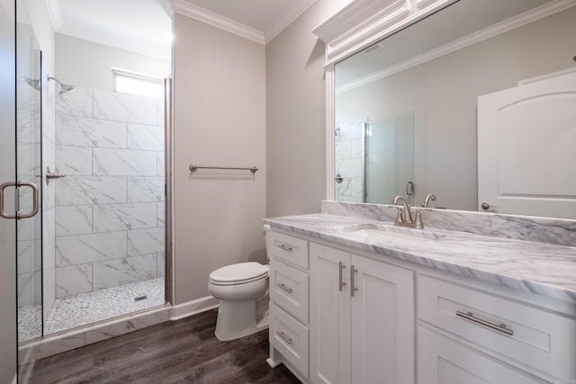 bathroom with walk in shower, ornamental molding, vanity, wood-type flooring, and toilet