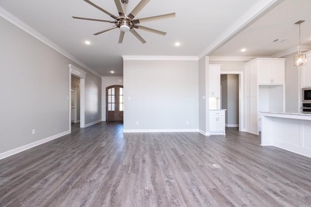 unfurnished living room featuring crown molding, french doors, ceiling fan, and dark wood-type flooring