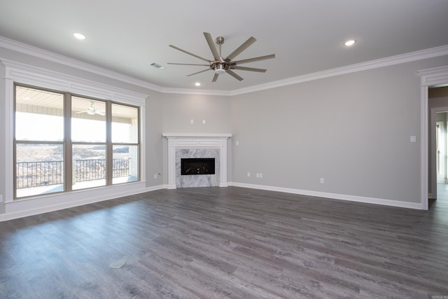 unfurnished living room with a fireplace, dark hardwood / wood-style floors, ceiling fan, and ornamental molding