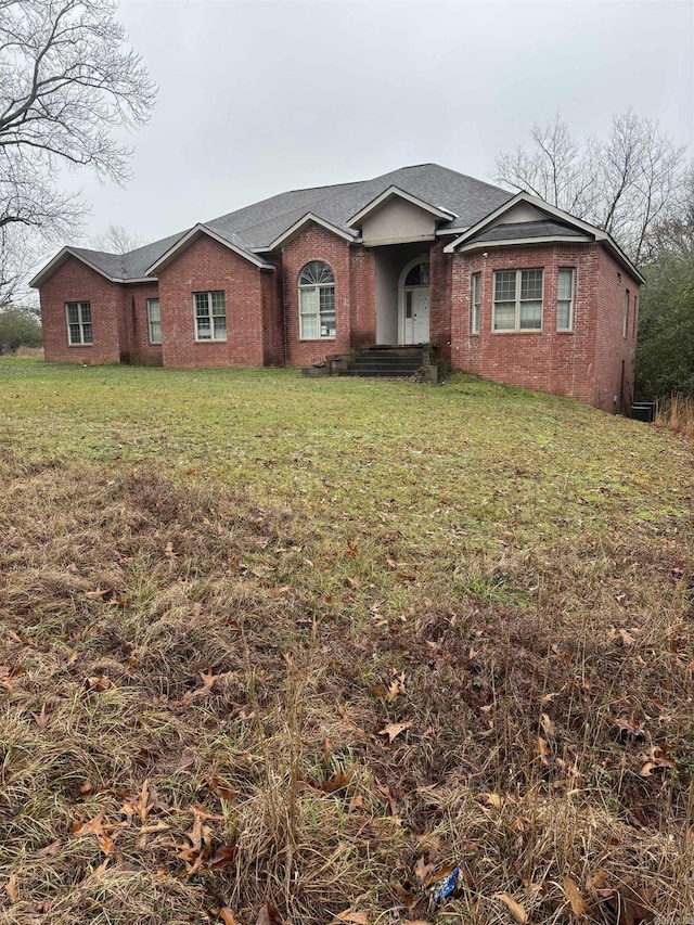 single story home featuring a front lawn and brick siding